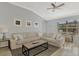 Cozy living room featuring a plush sectional sofa, side tables, and a textured rug at 11679 Anhinga Ave, Venice, FL 34292