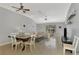 Open-concept living room with neutral tones, tile flooring, and abundant natural light at 11679 Anhinga Ave, Venice, FL 34292