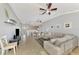 Spacious living area with tile floors, open layout and a view into the kitchen at 11679 Anhinga Ave, Venice, FL 34292