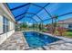 Inviting screened-in pool and patio area offering a tranquil retreat with blue skies and lush greenery at 11679 Anhinga Ave, Venice, FL 34292
