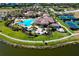 Community clubhouse and pool with surrounding landscape at 12313 Amica Loop, Venice, FL 34293