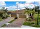 Two-story home with two-car garage and mature landscaping at 12313 Amica Loop, Venice, FL 34293