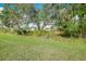Landscaped backyard with lush greenery and mature trees at 12313 Amica Loop, Venice, FL 34293