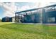 Spacious backyard with covered patio and lush lawn at 12313 Amica Loop, Venice, FL 34293