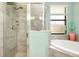 Bathroom with shower, soaking tub, and double vanity at 12313 Amica Loop, Venice, FL 34293