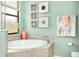 Bathroom with a corner soaking tub and coastal decor at 12313 Amica Loop, Venice, FL 34293