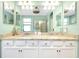Double vanity bathroom with granite countertop at 12313 Amica Loop, Venice, FL 34293