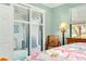 Bedroom with patio access and coastal decor at 12313 Amica Loop, Venice, FL 34293