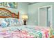 Bedroom with coastal bedding and a sitting area at 12313 Amica Loop, Venice, FL 34293