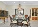 Bright dining area with glass table and rattan chairs at 12313 Amica Loop, Venice, FL 34293