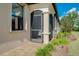 Home exterior featuring a screened patio and landscaping at 12313 Amica Loop, Venice, FL 34293