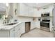 Modern kitchen with stainless steel appliances and white cabinetry at 12313 Amica Loop, Venice, FL 34293