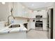 Modern kitchen with stainless steel appliances and white cabinetry at 12313 Amica Loop, Venice, FL 34293