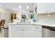Modern kitchen with stainless steel appliances and white cabinetry at 12313 Amica Loop, Venice, FL 34293