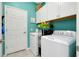 Laundry room with washer, dryer, and extra storage at 12313 Amica Loop, Venice, FL 34293