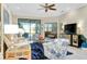 Bright and airy living room with patio access and ceiling fan at 12313 Amica Loop, Venice, FL 34293