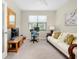 Home office with a comfortable sofa and workspace at 12313 Amica Loop, Venice, FL 34293