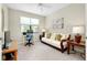 Home office with a comfortable sofa and workspace at 12313 Amica Loop, Venice, FL 34293