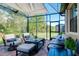 Relaxing screened patio with comfortable seating and table at 12313 Amica Loop, Venice, FL 34293