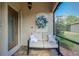 Relaxing screened porch with comfy seating and wreath at 12313 Amica Loop, Venice, FL 34293