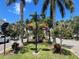 Scenic street view with hanging flower baskets and lush landscaping at 12313 Amica Loop, Venice, FL 34293