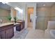 Spa-like bathroom with double vanity, shower, and soaking tub at 140 Maraviya Blvd, Nokomis, FL 34275