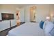 Bedroom with king-size bed, TV, and access to a full bathroom at 140 Maraviya Blvd, Nokomis, FL 34275