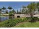 Stone bridge over water feature in a landscaped community at 140 Maraviya Blvd, Nokomis, FL 34275