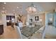 Open dining room with glass table, white chairs, and kitchen views at 140 Maraviya Blvd, Nokomis, FL 34275