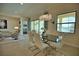 Elegant dining room features a glass table, white chairs and views of the water at 140 Maraviya Blvd, Nokomis, FL 34275