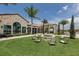 Relaxing fire pit area with lounge chairs near clubhouse at 140 Maraviya Blvd, Nokomis, FL 34275