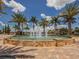 Circular fountain with palm trees and paved walkways at 140 Maraviya Blvd, Nokomis, FL 34275