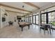 Game room with pool table and large windows at 140 Maraviya Blvd, Nokomis, FL 34275