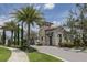 Gated community entrance with guard house and palm trees at 140 Maraviya Blvd, Nokomis, FL 34275