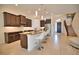 Island kitchen with granite countertops, stainless steel appliances, and breakfast bar at 140 Maraviya Blvd, Nokomis, FL 34275