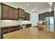 Spacious kitchen with granite countertops, stainless steel appliances, and dark wood cabinets at 140 Maraviya Blvd, Nokomis, FL 34275