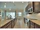 Open kitchen boasts granite counters, stainless steel appliances, and an island at 140 Maraviya Blvd, Nokomis, FL 34275