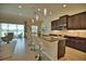 Modern kitchen with dark cabinetry, granite countertops and breakfast bar at 140 Maraviya Blvd, Nokomis, FL 34275