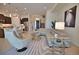 Open living room featuring a sectional sofa, coffee table, and kitchen views at 140 Maraviya Blvd, Nokomis, FL 34275