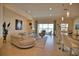 Open living space with a large sectional sofa, access to a lanai, and kitchen at 140 Maraviya Blvd, Nokomis, FL 34275