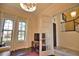Home office with hardwood floors, large windows, and French doors at 140 Maraviya Blvd, Nokomis, FL 34275