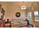 Home office with hardwood floors, comfortable seating, and large windows at 140 Maraviya Blvd, Nokomis, FL 34275