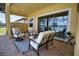 Covered patio with comfortable seating, offering a peaceful lake view at 140 Maraviya Blvd, Nokomis, FL 34275