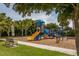 playground with play structures and shaded seating at 140 Maraviya Blvd, Nokomis, FL 34275