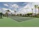 Community tennis court with green surface and surrounding landscape at 140 Maraviya Blvd, Nokomis, FL 34275