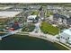 Aerial view of a waterfront community with shops and a park at 1678 Quail Lake Dr, Venice, FL 34293