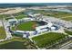 Aerial view of a baseball stadium with surrounding parking and landscape at 1678 Quail Lake Dr, Venice, FL 34293