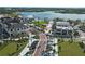 Aerial view of a town center with shops, lake, and green spaces at 1678 Quail Lake Dr, Venice, FL 34293