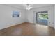 A bright bedroom with sliding glass doors to the pool and tiled floors at 1678 Quail Lake Dr, Venice, FL 34293