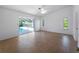 Spacious bedroom with natural light, tiled flooring, and pool view at 1678 Quail Lake Dr, Venice, FL 34293